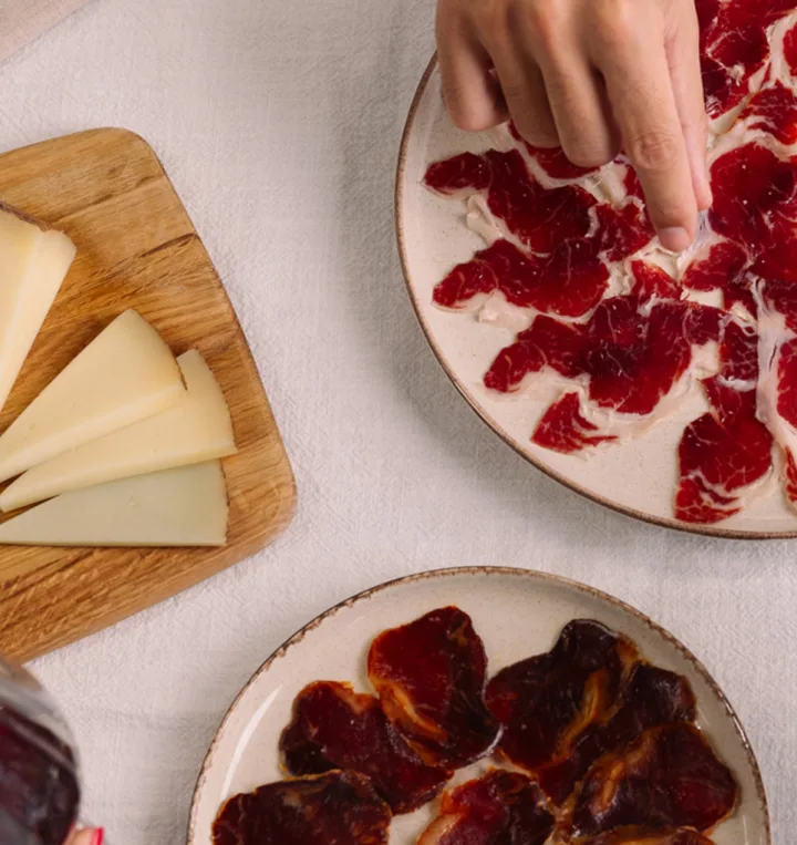 Plates of Iberian ham and cured cheese